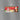 Graphic image of a Little Debbie Christmas Tree Cake carton magnet. The magnet is 3.1 inches wide and 1.3 inches tall, depicting a festive red package adorned with images of the Little Debbie logo, a smiling Santa Claus holding a gift, and a Christmas Tree Cake decorated with green frosting and red sprinkles. Additionally, there are images of the actual snack cakes, sliced to show their creamy filling.
