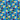 Close up view of a Little Debbie® 90s Retro Zebra Cakes T-shirt. The shirt is predominantly blue with a vibrant pattern of iconic Zebra Cakes, along with playful yellow, green, and red shapes, squiggly lines and dots reminiscent of the 90s design aesthetics.
