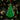 A Little Debbie® Christmas Tree Brownie® Ornament shaped like a green frosted Christmas tree brownie decorated with colorful candy pieces, hanging by a red ribbon in front of a softly lit Christmas tree background.