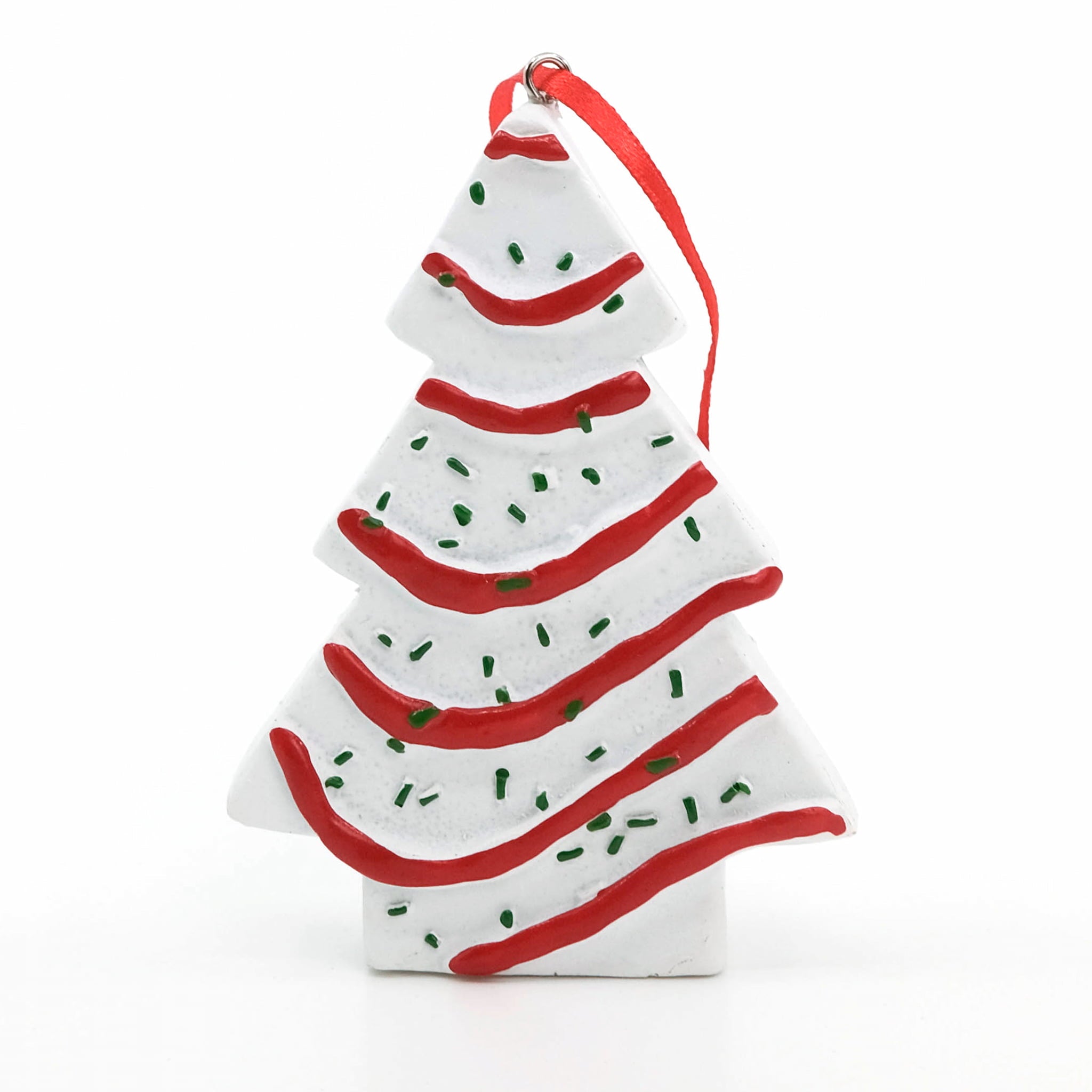 A Little Debbie Christmas Tree Cake® Ornament shaped like a white frosted tree with red icing stripes and green sprinkle details, hanging from a red ribbon against a white background.