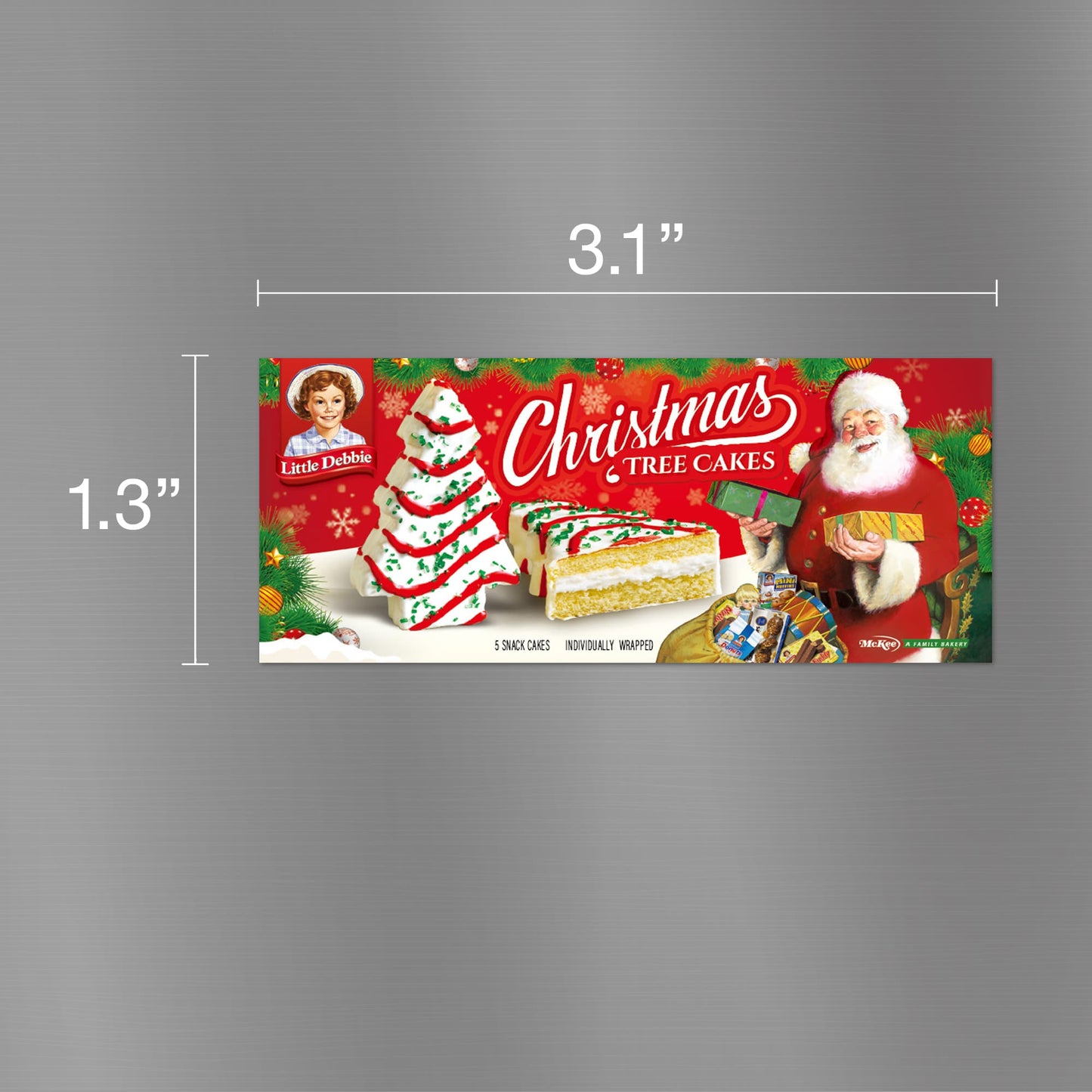 Graphic image of a Little Debbie Christmas Tree Cake carton magnet. The magnet is 3.1 inches wide and 1.3 inches tall, depicting a festive red package adorned with images of the Little Debbie logo, a smiling Santa Claus holding a gift, and a Christmas Tree Cake decorated with green frosting and red sprinkles. Additionally, there are images of the actual snack cakes, sliced to show their creamy filling.