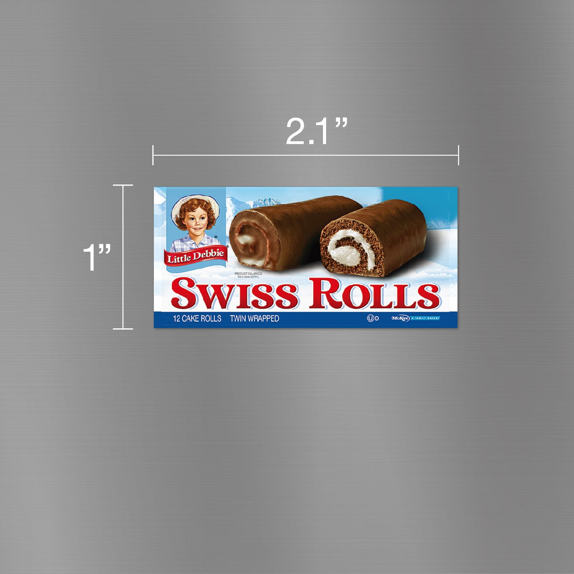 Image of a Little Debbie Swiss Rolls carton magnet, measuring 2.1 inches wide and 1 inch tall. The magnet displays the classic blue and red packaging featuring two Swiss Rolls with their chocolate coating and creamy swirl filling visible. The Little Debbie logo is positioned at the top left, and the text 'Swiss Rolls' in bold red letters is below, with the information '12 cake rolls, twin wrapped' noted on the package.