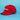 A red baseball cap with 'Little Debbie' embroidered in white on the front, set against a solid light blue background.