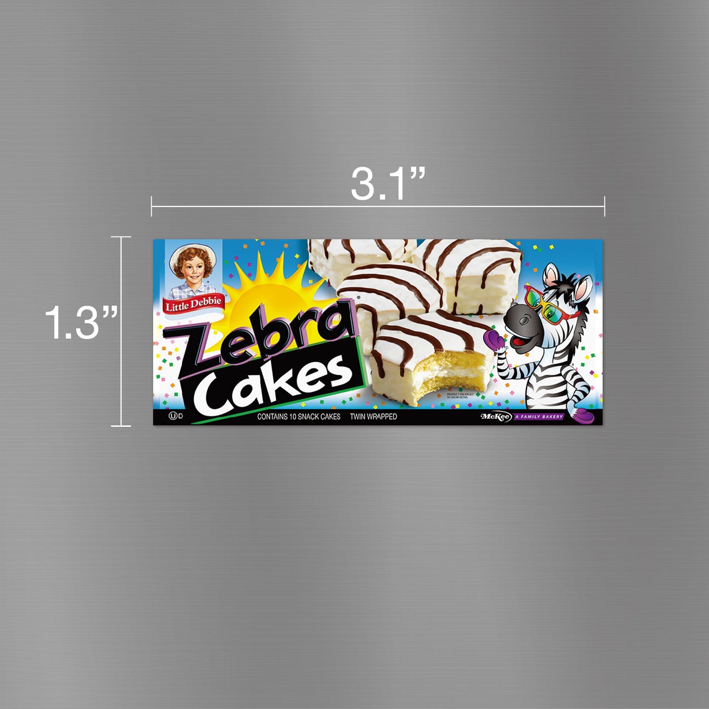 Image of a Little Debbie Zebra Cakes carton magnet, measuring 3.1 inches wide and 1.3 inches tall. The magnet displays a playful design featuring a zebra character holding an ice cream cone, set against a colorful backdrop with a depiction of the actual Zebra Cake snack. The packaging includes the Little Debbie logo and mentions 'contains 10 snack cakes, twin wrapped'.