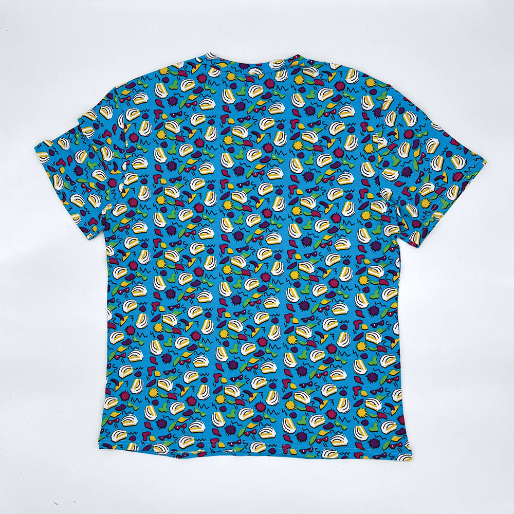 Back view of a Little Debbie® 90s Retro Zebra Cakes T-shirt. The shirt is predominantly blue with a vibrant pattern of iconic Zebra Cakes, along with playful yellow, green, and red shapes, squiggly lines and dots reminiscent of the 90s design aesthetics. The T-shirt has a round neckline and short sleeves.