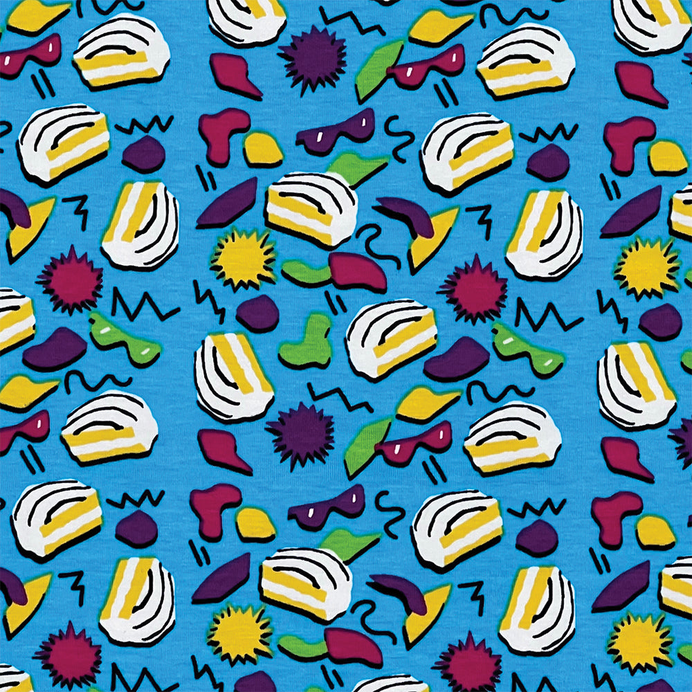 Close up view of a Little Debbie® 90s Retro Zebra Cakes T-shirt. The shirt is predominantly blue with a vibrant pattern of iconic Zebra Cakes, along with playful yellow, green, and red shapes, squiggly lines and dots reminiscent of the 90s design aesthetics.