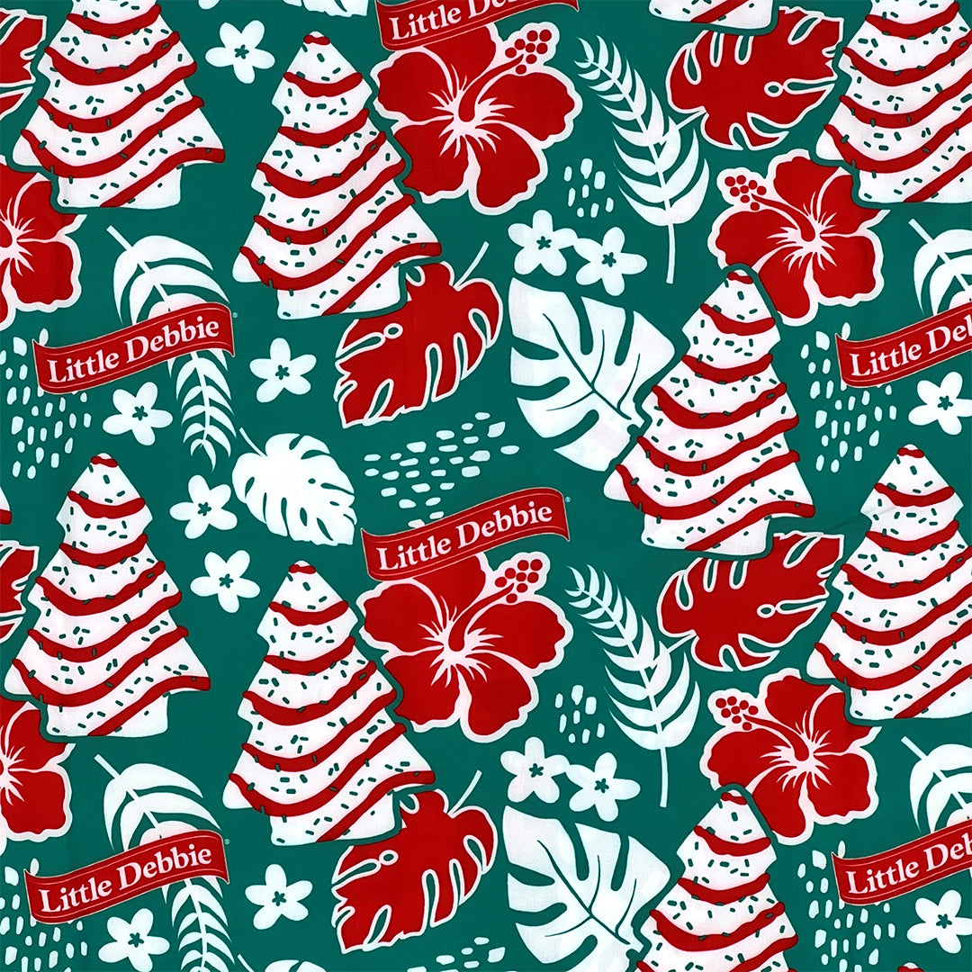 Close-up of the pattern on a green Little Debbie Hawaiian shirt, showcasing a design of Little Debbie Christmas Tree Cakes, Red Ribbon Logos, and an aloha pattern of leaves and flowers.