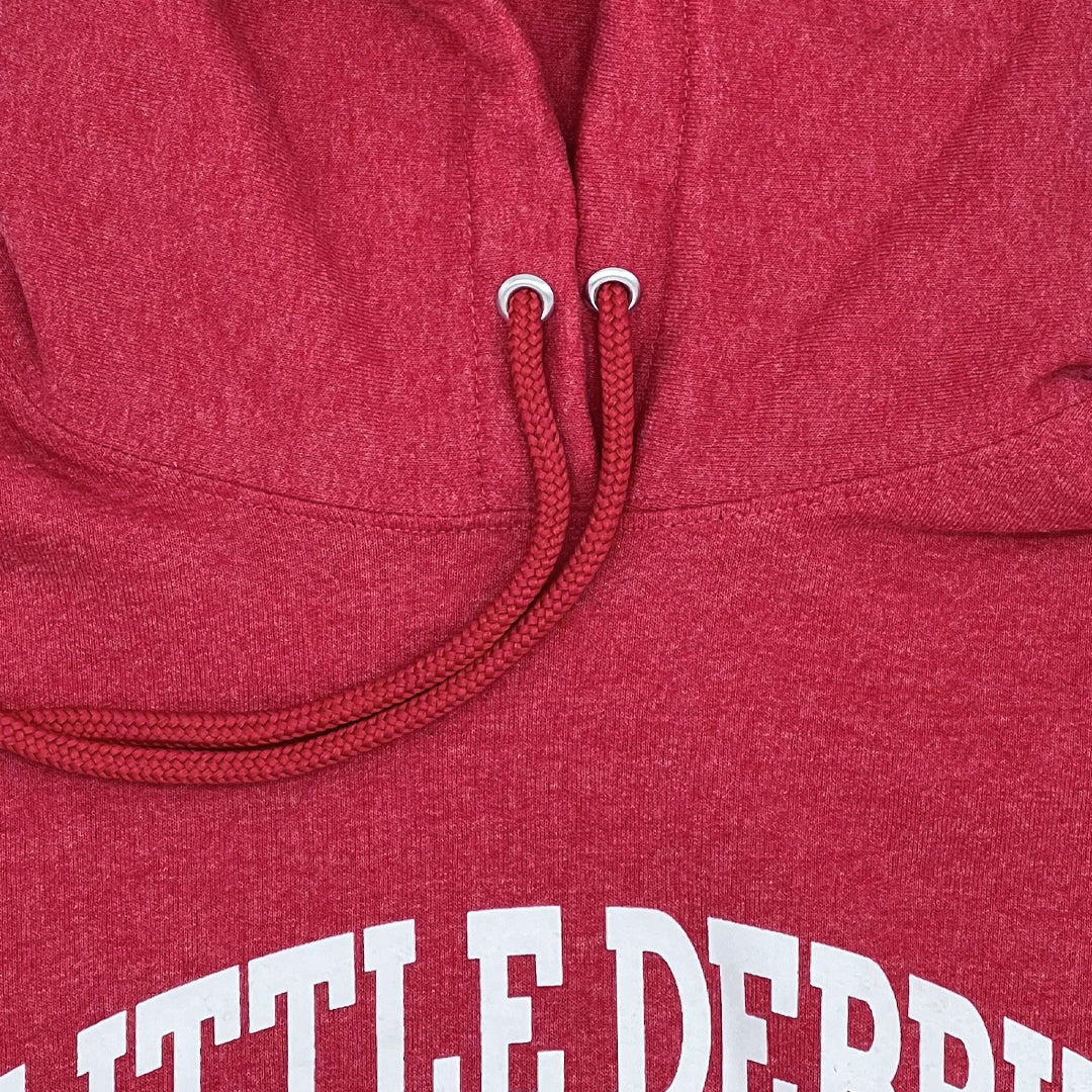 Close-up of a red hoodie's neckline and drawstrings. The drawstrings are braided with metal-tipped aglets. Partial white text reading 'LITTLE.DEBBIE' can be seen at the bottom of the image.