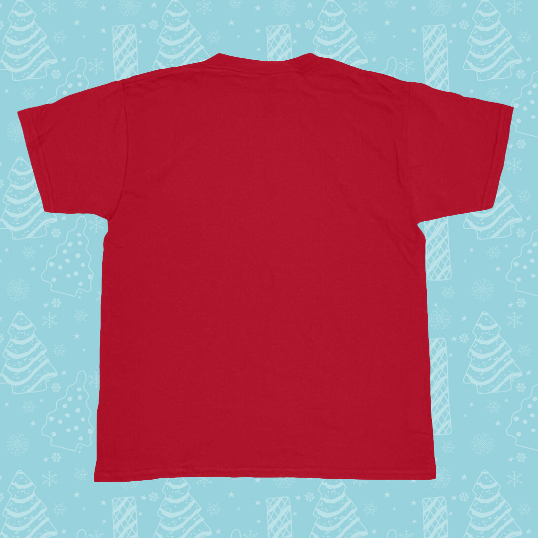 A plain red youth T-shirt is displayed flat against a light blue background with a festive pattern of white Christmas trees and snowflakes. The shirt is short-sleeved with a round neckline, and there are no visible designs or text on the back of the shirt shown in the image.