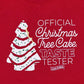 Close-up view of a red Little Debbie® Christmas Tree Cake Taste Tester Youth Shirt with a white graphic design of a Little Debbie® Christmas Tree Cake on the left side. To the right of the graphic, white text reads 'OFFICIAL Christmas Tree Cake TASTE TESTER' with the Little Debbie® logo positioned at the bottom of the text. The shirt has a round neckline and is presented on a plain background.
