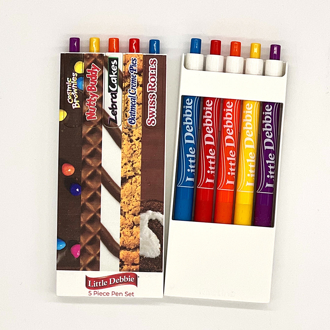 Front and back view of the Little Debbie Scribbles 5-piece pen set,  each inspired by a different iconic Little Debbie treat, with the back partially open revealing the Little Debbie Ribbon logo
