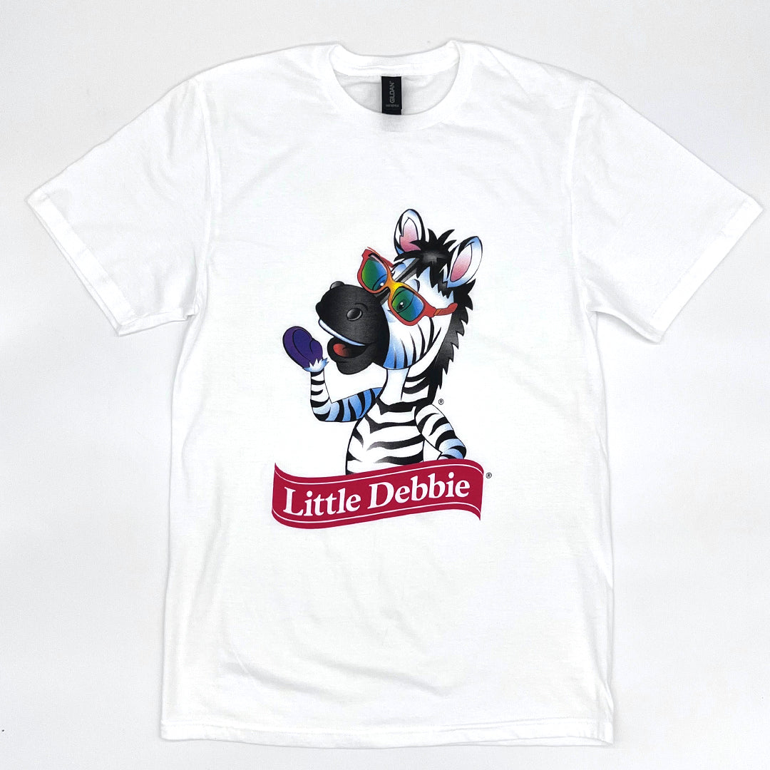 Front view of a white Little Debbie T-shirt featuring a 1/2 body image of Zain the Zebra™  waving, positioned above the Little Debbie Ribbon logo.
