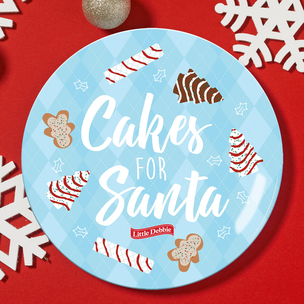 Little Debbie® Christmas plate with "Cakes for Santa" text and illustrations of North Pole Nutty Buddy®, Christmas Tree Cakes®, Gingerbread Man on a blue argyle background